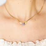 Lady-neckline-wearing-a-dainty-gold-plated-snake-chain-choker-necklace with-pastel-porcelain rose-and-tiny-gold-leaves.