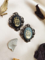 Vintage Three Graces cameo brooch in silver-tone Victorian frame with soft patina, featuring 1970s Japanese acrylic cameo depicting the daughters of Zeus and Eurynome.
