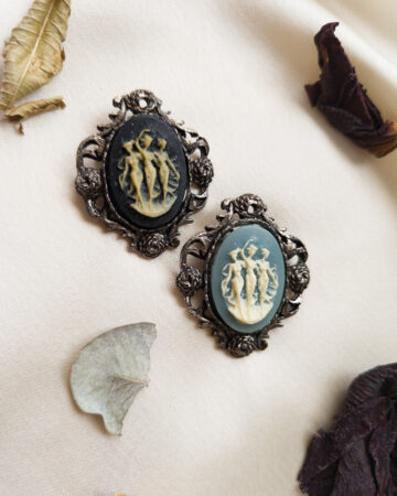 Vintage Three Graces cameo brooch in silver-tone Victorian frame with soft patina, featuring 1970s Japanese acrylic cameo depicting the daughters of Zeus and Eurynome.